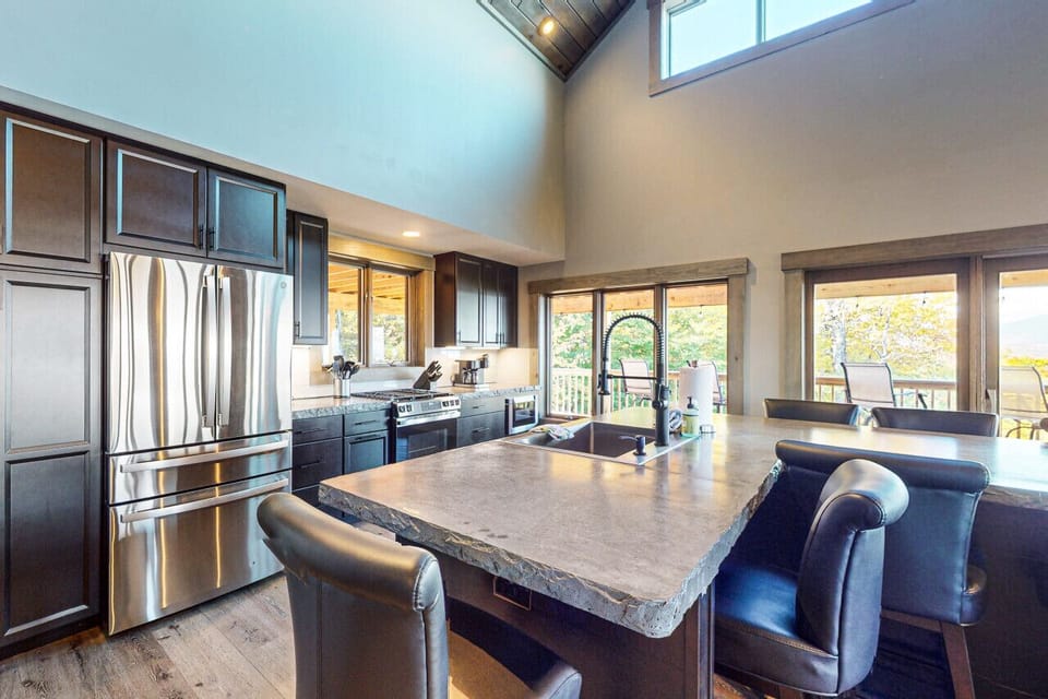 Modern kitchen with a large island, stainless steel appliances, and open-concept design.