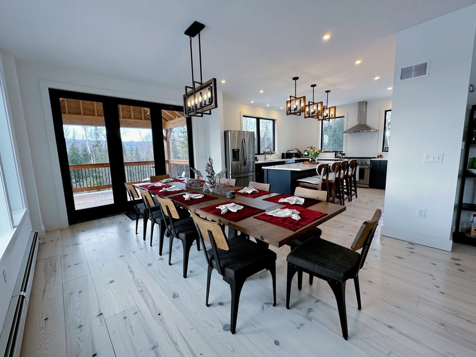 Dining area adjacent to kitchen and living room with mountain views