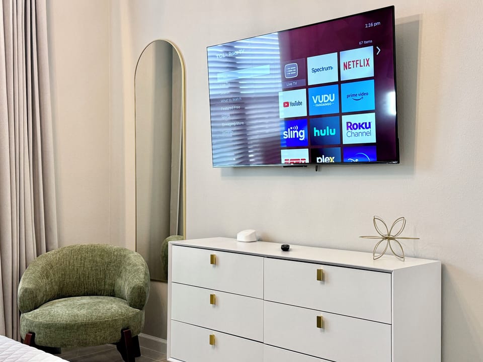 Smart TV, mirror and armchair, all complete for your comfort.