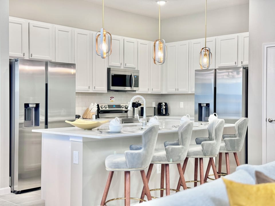 Beautiful kitchen in white and stainless steel tones with island