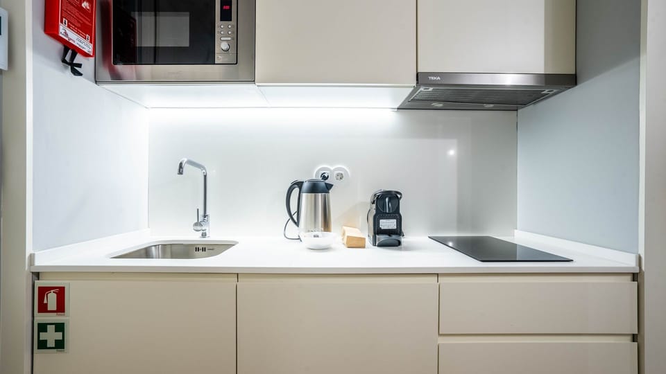 Prepare delightful meals or your morning coffee in this efficient and well-equipped kitchenette, featuring sleek integrated appliances and ample counter space. Everything you need for a convenient and enjoyable culinary experience is right at your fingert