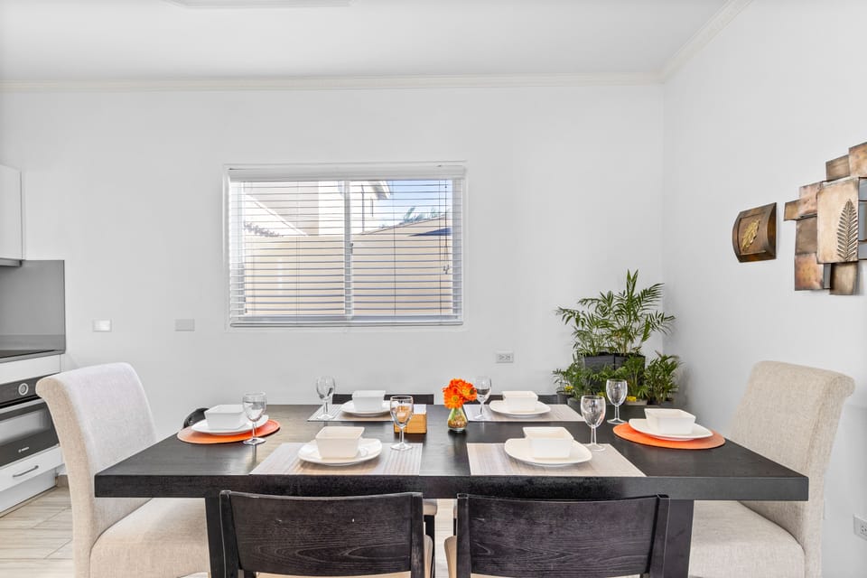 Marvelous dinning area of the apartment in Noord, Aruba - Beautiful window facing dinning area of the apartment - Elite 6 persons dinning - Stunningly located large windows with mesmerizing views - Majestic decored space with beautiful paintings