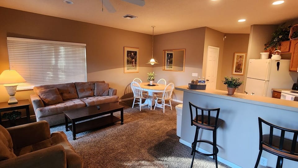 Open-concept living, dining, and kitchen space with comfortable seating and a warm, inviting layout.