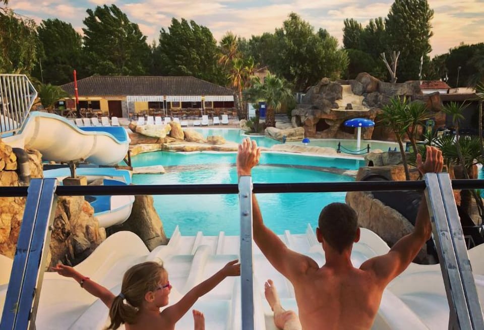 Friends enjoying a thrilling descent down the water slides, perfect for shared moments of excitement.