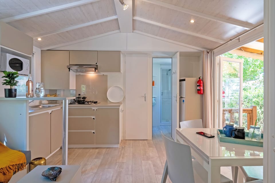 Bright and airy kitchen and dining area with modern decor, perfect for enjoying meals and gatherings.