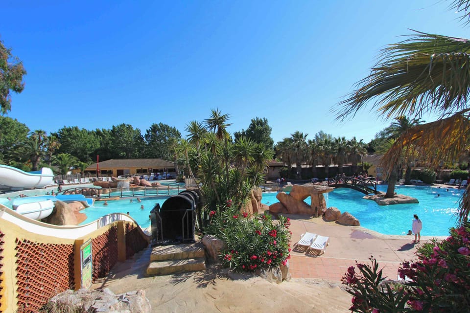 Tropical-style pool with lush surroundings, offering a refreshing oasis for relaxation.
