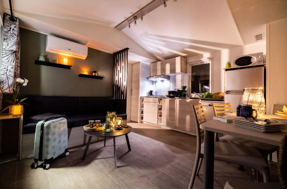 Modern living and dining space with warm lighting, creating a cozy ambiance perfect for relaxing evenings.