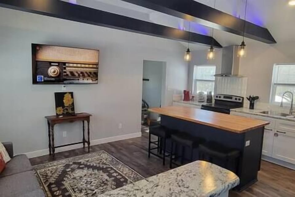 The open concept kitchen and living are at Pine Tree Corner Bungalow to relax and enjoy everything