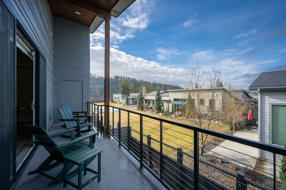 Unwind in your private balcony chairs while taking in panoramic mountain and neighborhood views under the expansive blue sky.