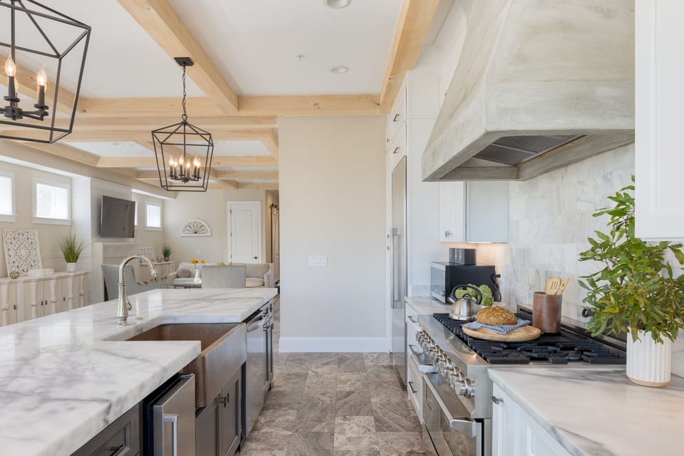 Marble counters and a wine fridge elevate the kitchen.