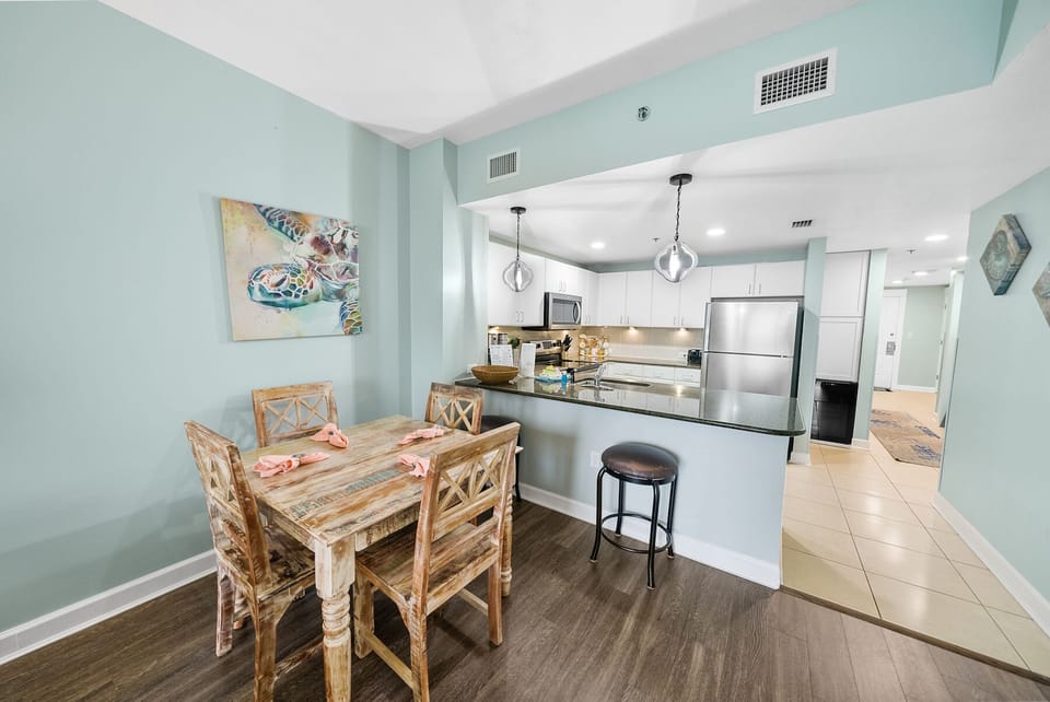Your bright, open kitchen flows seamlessly into a cozy dining space with coastal charm and modern convenience.