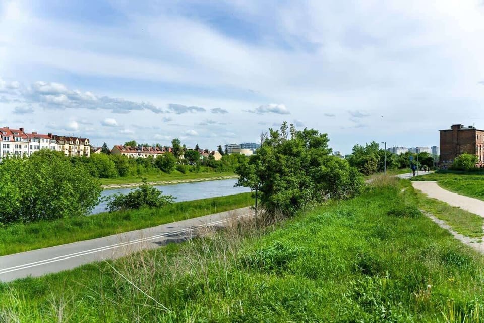 A peaceful riverside path with green landscapes, offering a perfect spot for walking or cycling while enjoying the natural surroundings.






