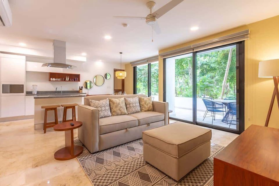 Spacious and luminous open living area with floor-to-ceiling glass doors