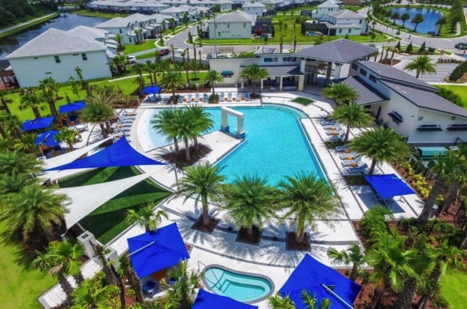 Unwind by the sparkling pool, embraced by lush palm trees and vibrant blue cabanas, perfect for sun-soaked afternoons. Enjoy the spacious lounge area and take in the scenic views of beautifully manicured landscaping.