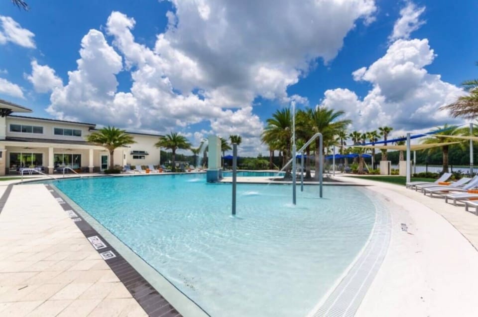 Enjoy sunny days by the beautiful pool with glistening waters and lush palm trees. Relax on comfy loungers in this outdoor oasis, perfect for leisurely afternoons in a serene and inviting atmosphere.