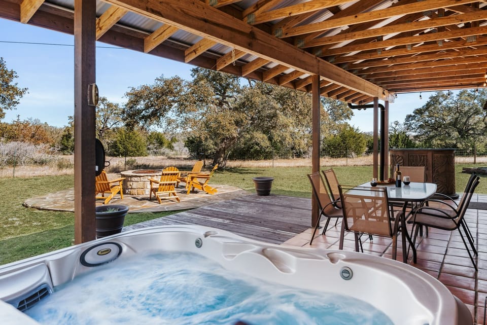 Hot tub on a covered porch - you can relax rain or shine!