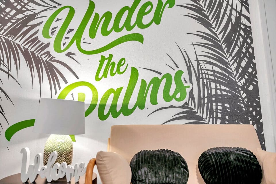 Playful wall mural w/ palm details adding personality and a fun tropical touch