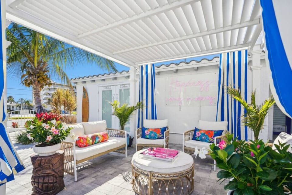Shaded outdoor cabana w/ cozy seating, colorful accents, and a breezy place to unwind.