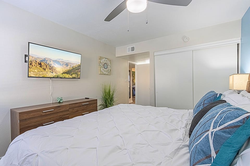 Cozy bedroom with a mounted TV and calming vibes.