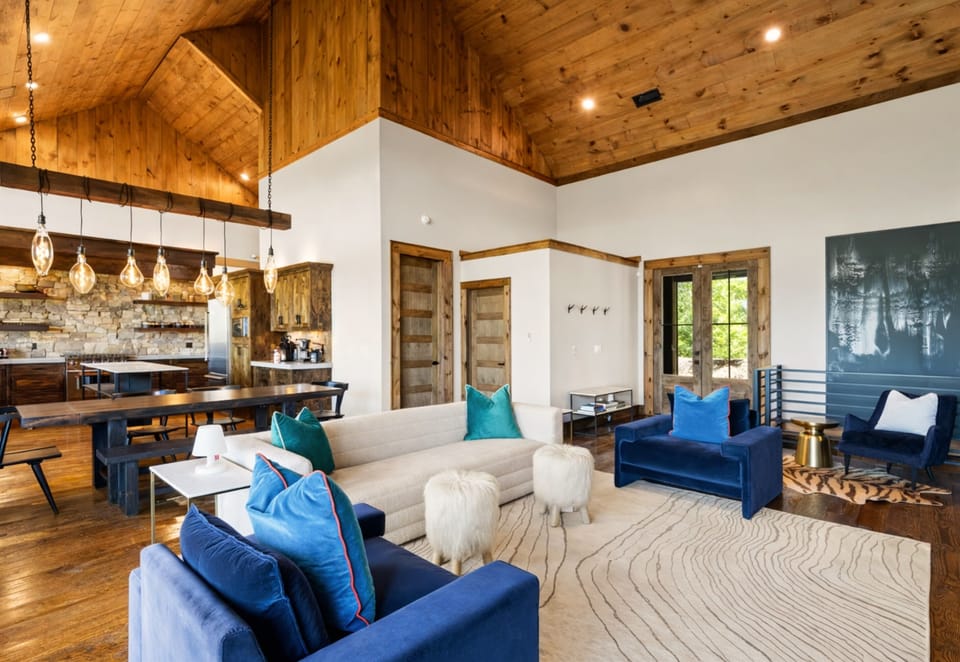 A cozy and inviting living room with warm decor, ample seating, and incredible views of the mountains.