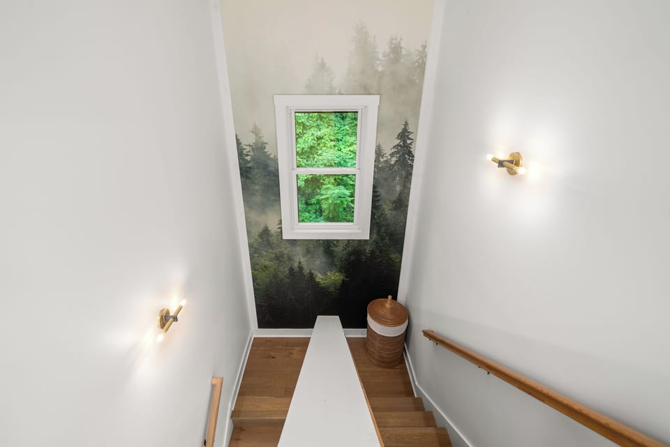Staircase to the bedrooms featuring floor to ceiling wallpaper. 