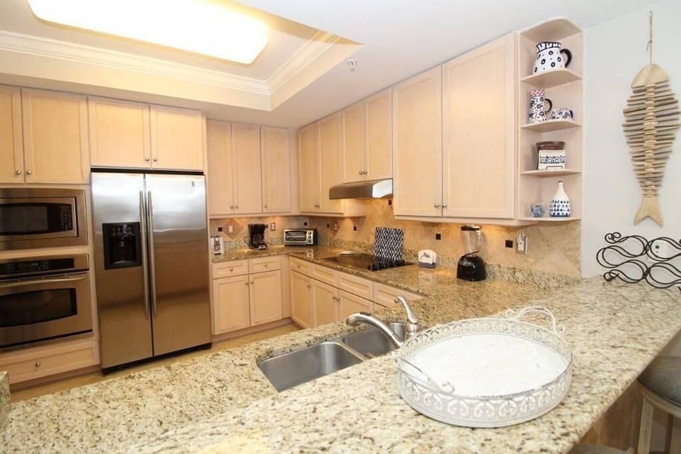 Condo, Multiple Beds (Indigo East 605) | Private kitchen | Oven, toaster, paper towels