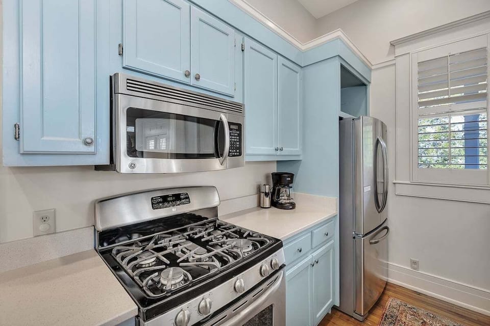 Close-up of kitchen stovetop and blue cabinetry