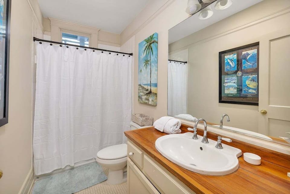 Bathroom with wooden counterspace and walk-in shower