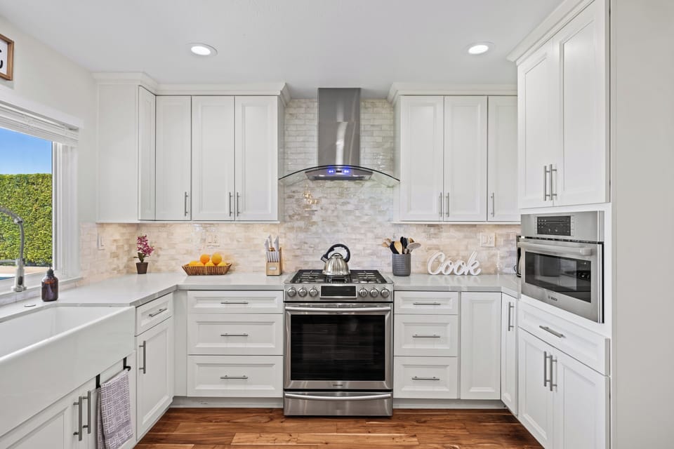 Stylish kitchen with gas range, roomy storage, and sleek, modern finishes.