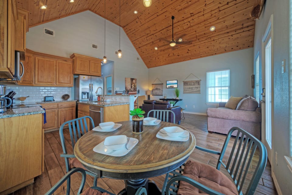 Open kitchen and dining area with vaulted wood ceilings and easy flow into the living room.