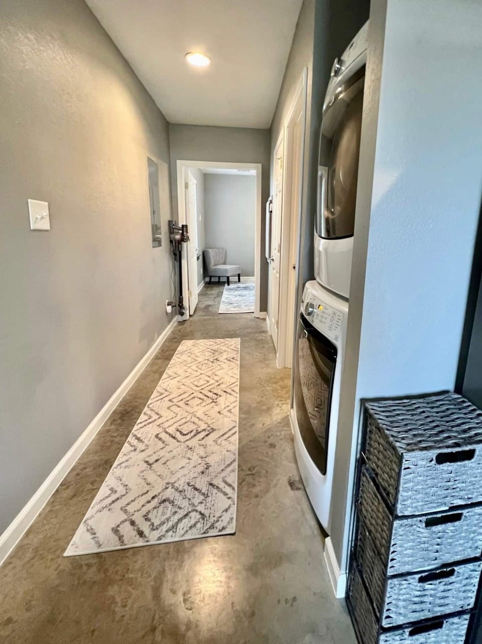 Back hallway to king bedroom. Laundry is located in this hallway, supplies are in the caddy pictured. King bathroom is located on the right side of the hall.