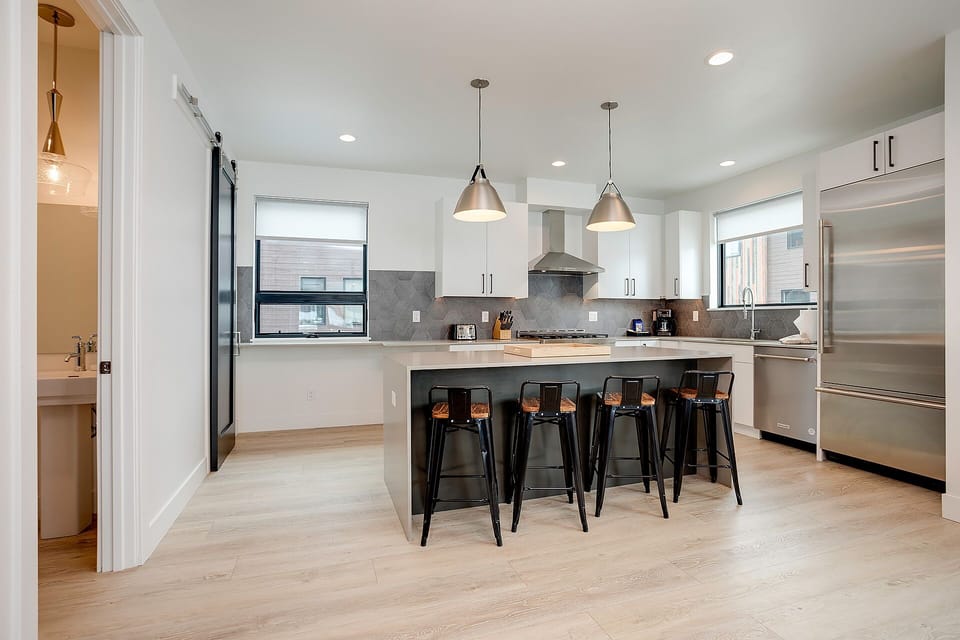 Cook with ease in your sleek kitchen featuring modern appliances, granite counters, and spacious island perfect for morning coffee or evening gatherings.
