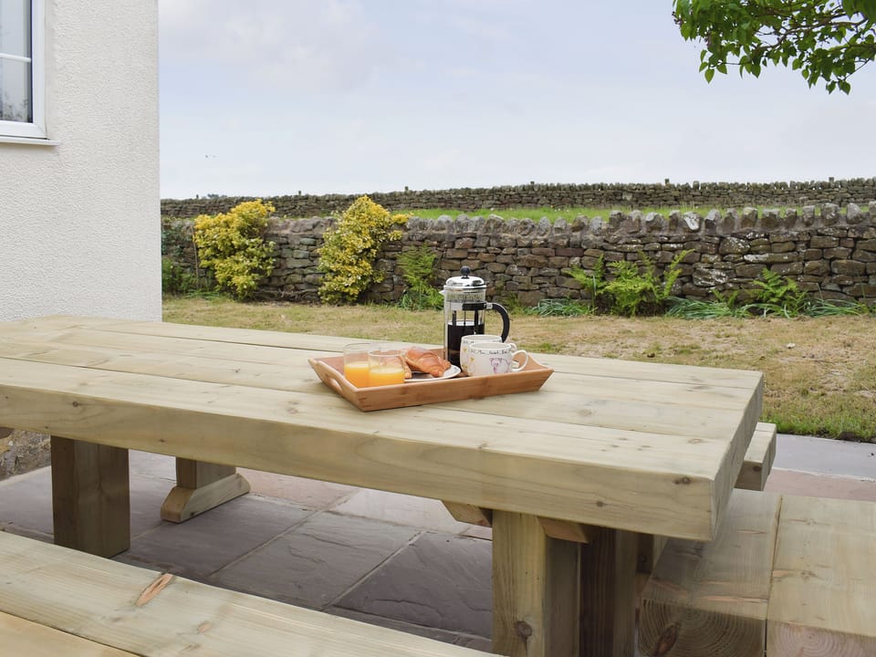 Paved patio area with outdoor furniture | Rudda Farm Cottage - Rudda Farm Cottages, Staintondale, near Whitby