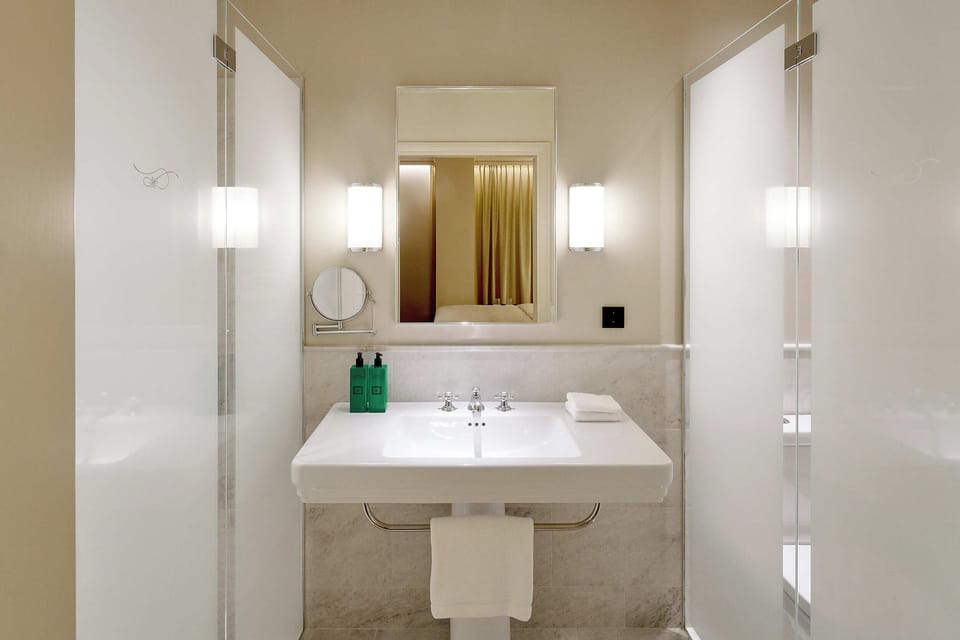 Shower, rainfall showerhead, designer toiletries, hair dryer
