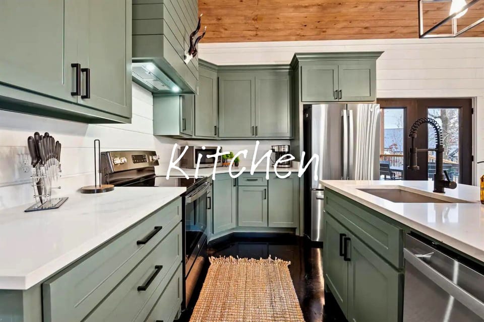 A streamlined kitchen boasts sage cabinetry and white countertops, providing functional space for culinary creation.