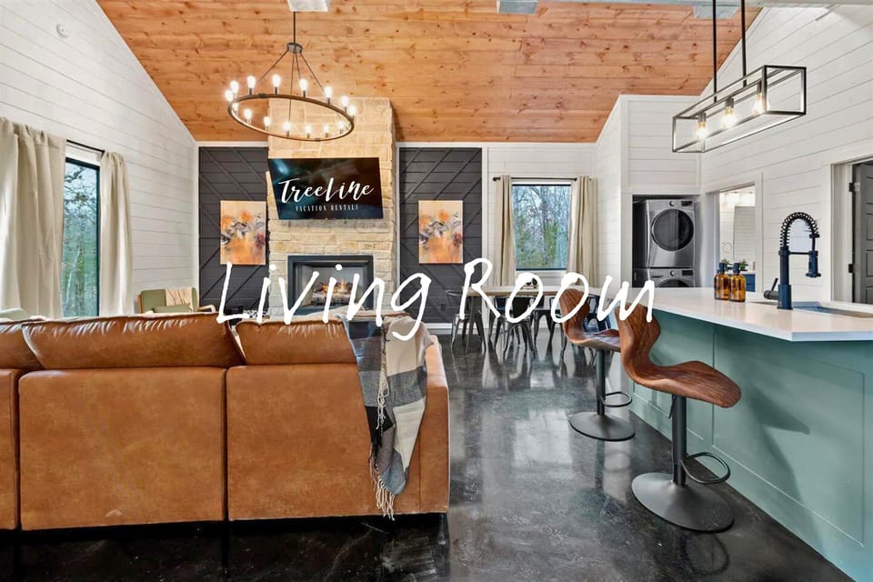 The open-plan space gracefully integrates the living room and kitchen, featuring a kitchen island and comfortable seating for casual dining and socializing.