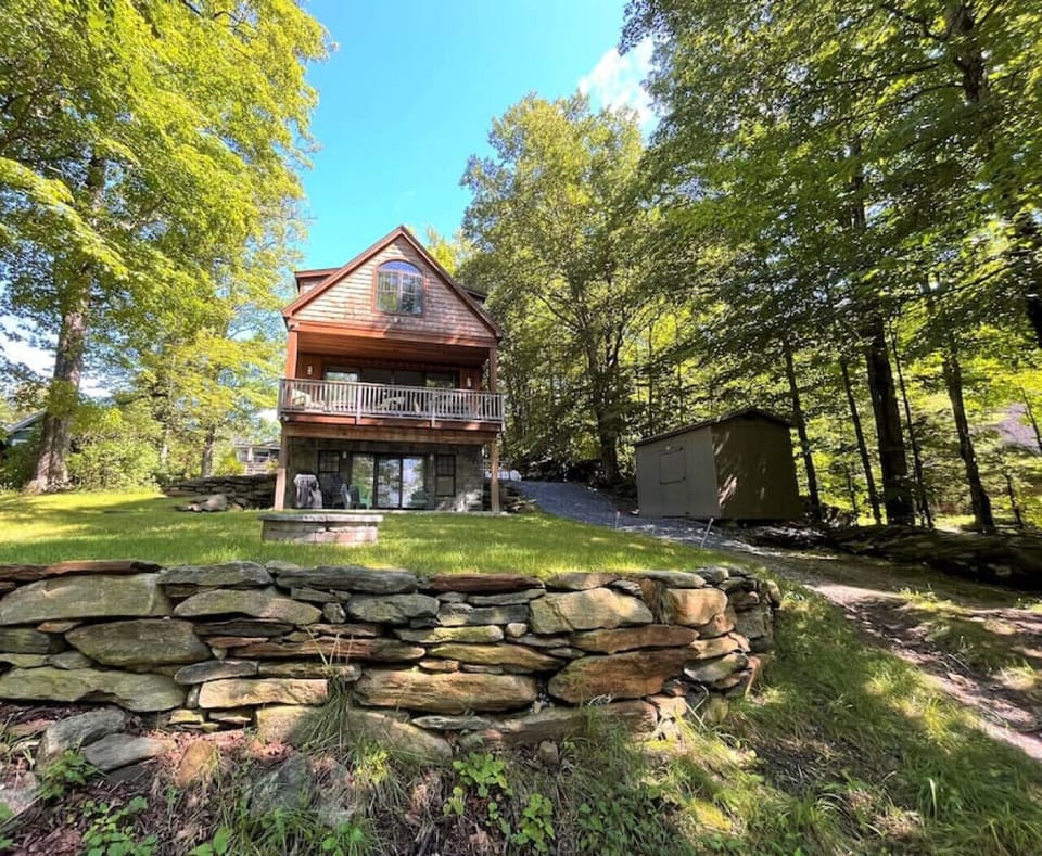Rear of home facing lake. 2 patios to enjoy the outdoors. Outdoor seating and Weber propane BBQ provided.