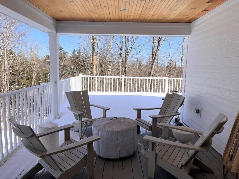Outdoor firepit under cover porch. Porch is wrap around the entire rear part of the home