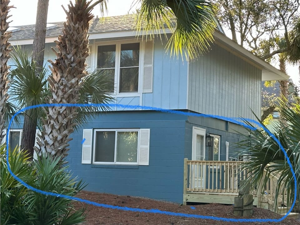 Outside entrance to first level studio apt with deck. 