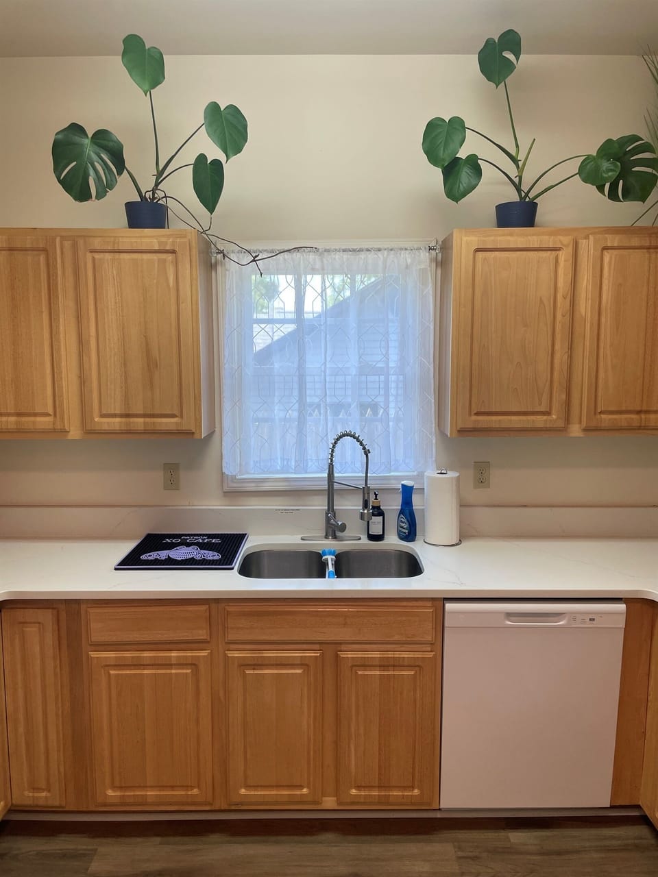 Updated kitchen featuring white quartz tops, stove/oven, full sized fridge, microwave,  and dish washer!