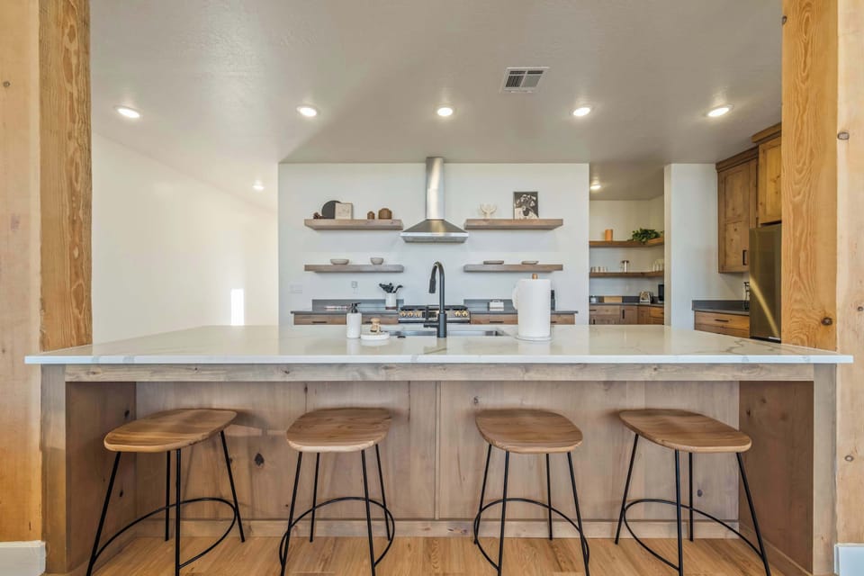 Gather around the oversized island—perfect for morning coffee, family meals, and late-night conversations.