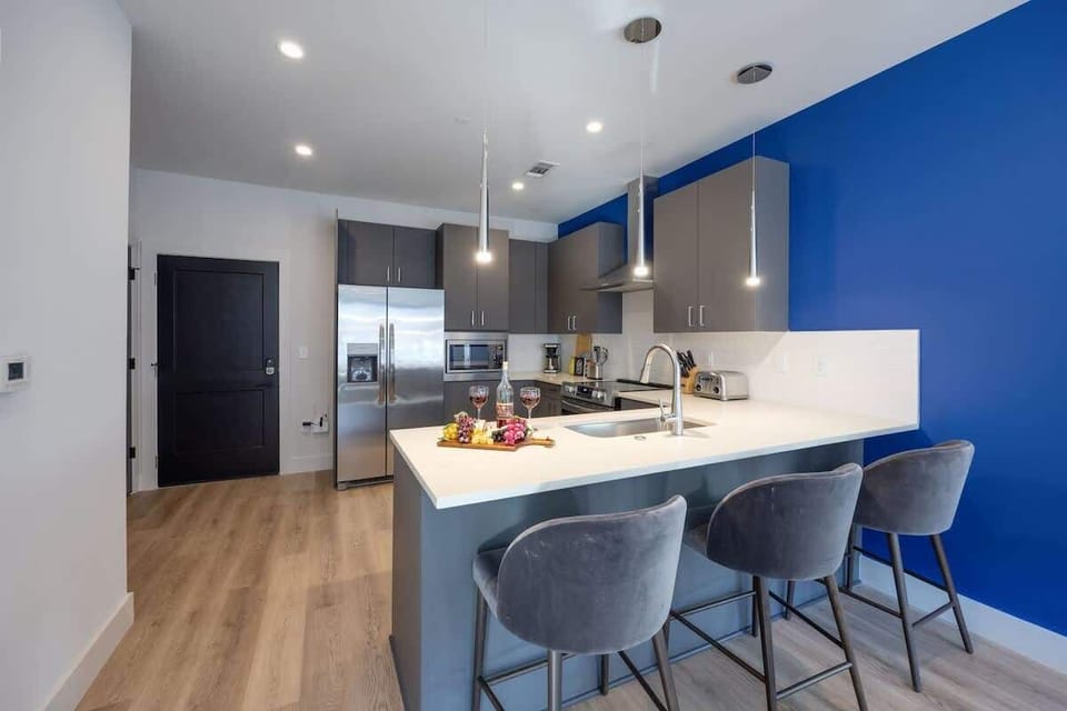 Unit 1: Fully equipped kitchen stocked with your basic cooking essentials, stainless-steel appliances, and breakfast bar seating.