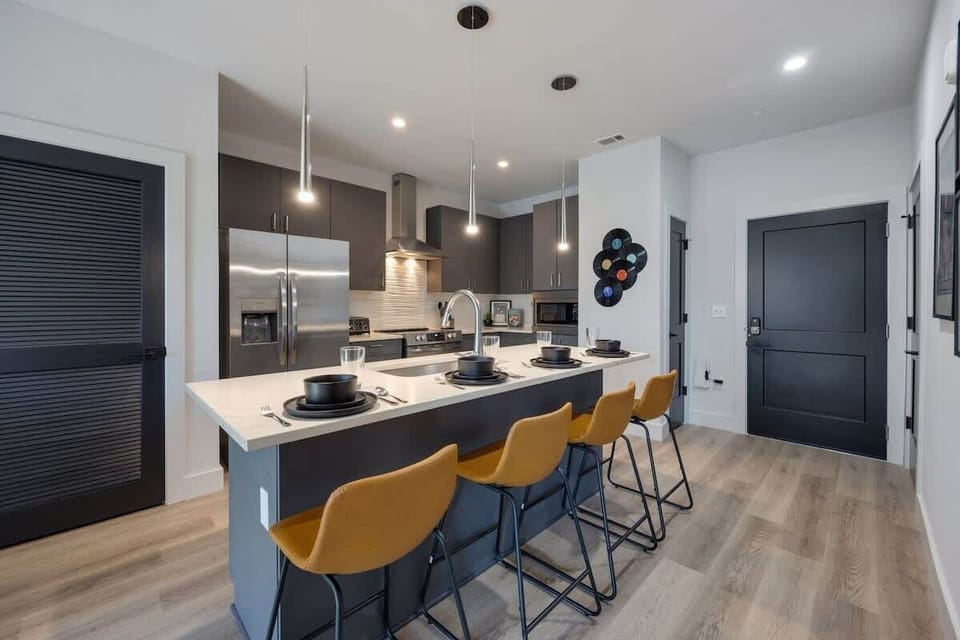Unit 2: Fully equipped kitchen stocked with your basic cooking essentials, stainless steel appliances, and breakfast bar seating.