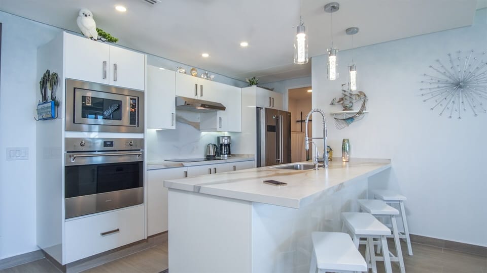 Bar stools accent the kitchen countertop.