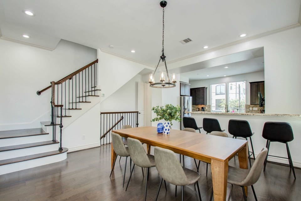 Elegant Dining Area with Open Kitchen & Modern Staircase