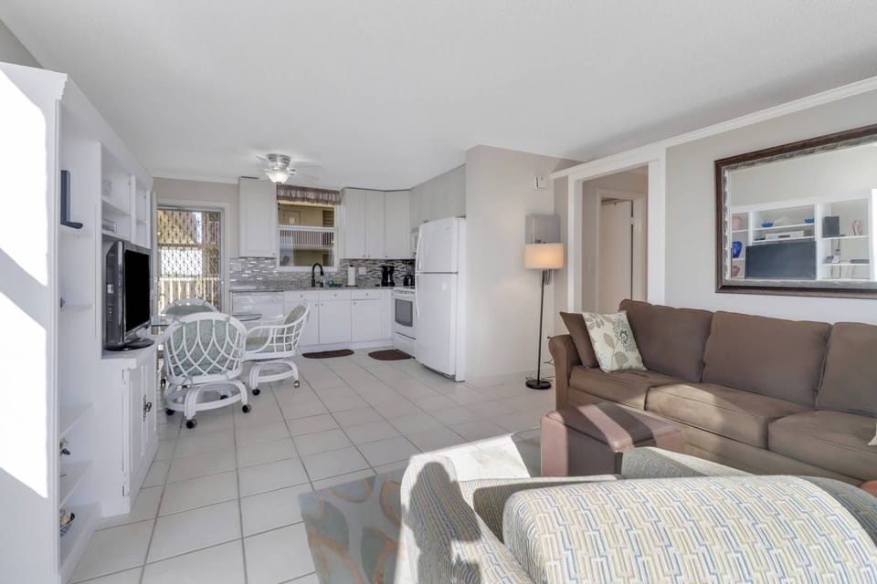 The partial wall with pocket door provides visual privacy between the main living area and sleeping space.