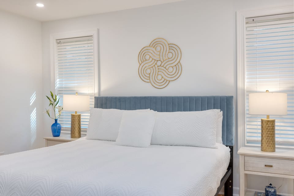 Primary bedroom features a king bed, TV, and ensuite bathroom.