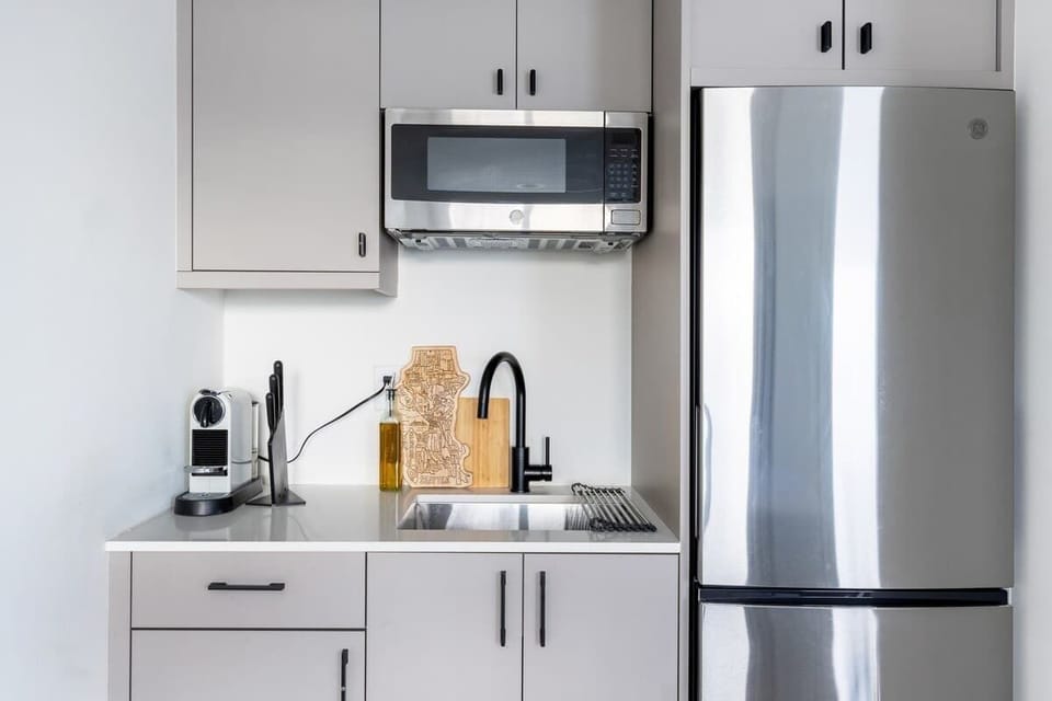 Stylish compact kitchen featuring contemporary finishes, stainless appliances, and smart use of space.