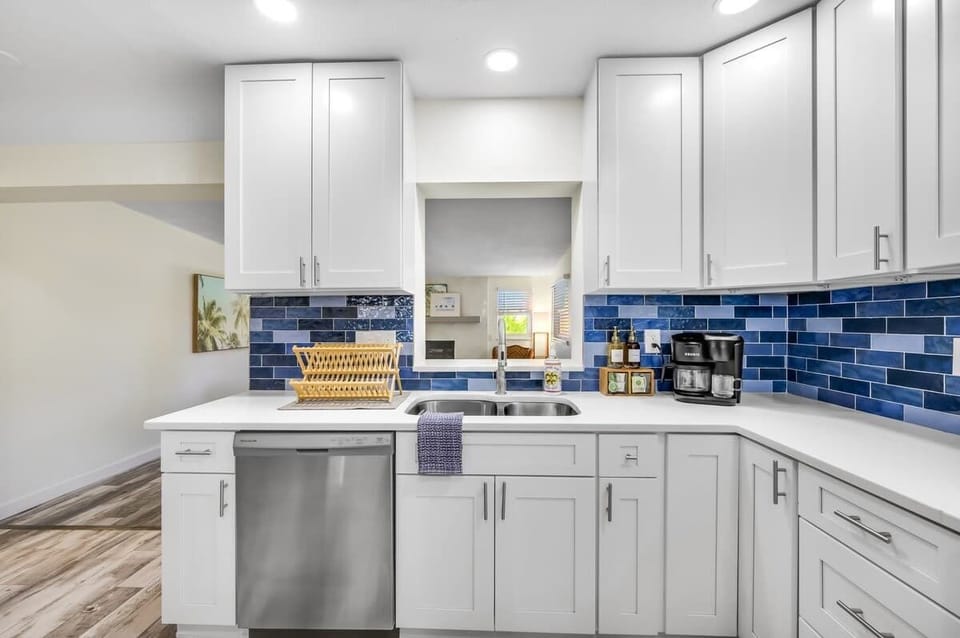 In the small coffee bar, you'll find a Keurig K-Duo machine along with K-cups, Sugar in the Raw packets, coffee filters, ground coffee, Torani French Vanilla, and Cinnamon Brown Sugar syrups.