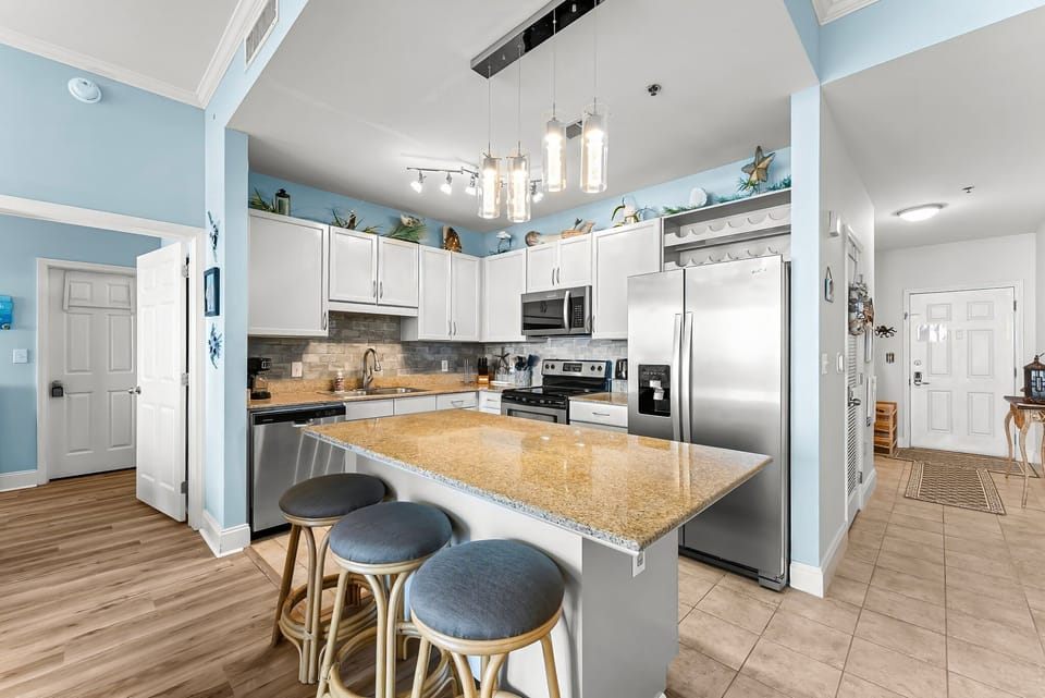 Modern kitchen with granite island and stainless steel appliances